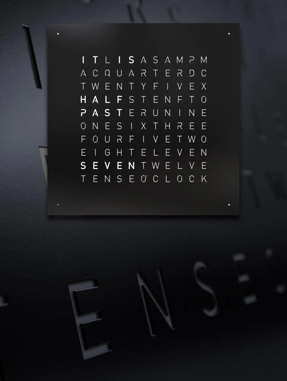 Front view of QLOCKTWO EARTH 45 Black Pepper wall clock with typographic time display