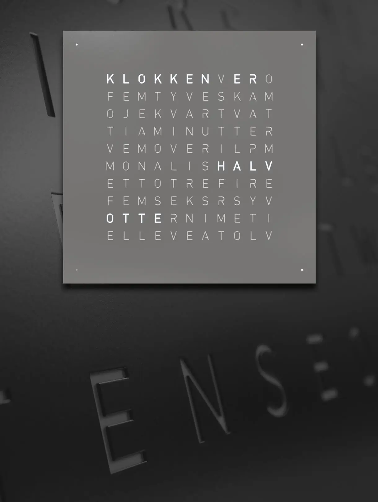 Front view of QLOCKTWO EARTH 45 Grey Pepper wall clock with typographic time display