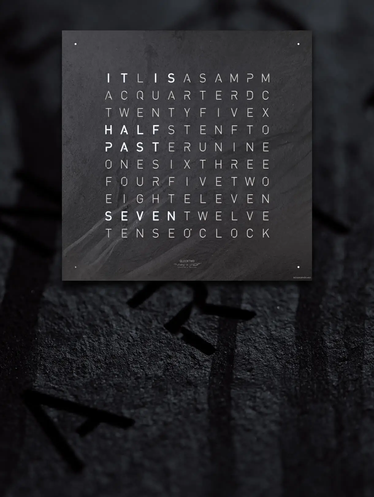 Front view of the QLOCKTWO EARTH 45 CREATOR'S EDITION METAMORPHITE word clocks for the wall with slate stone front cover