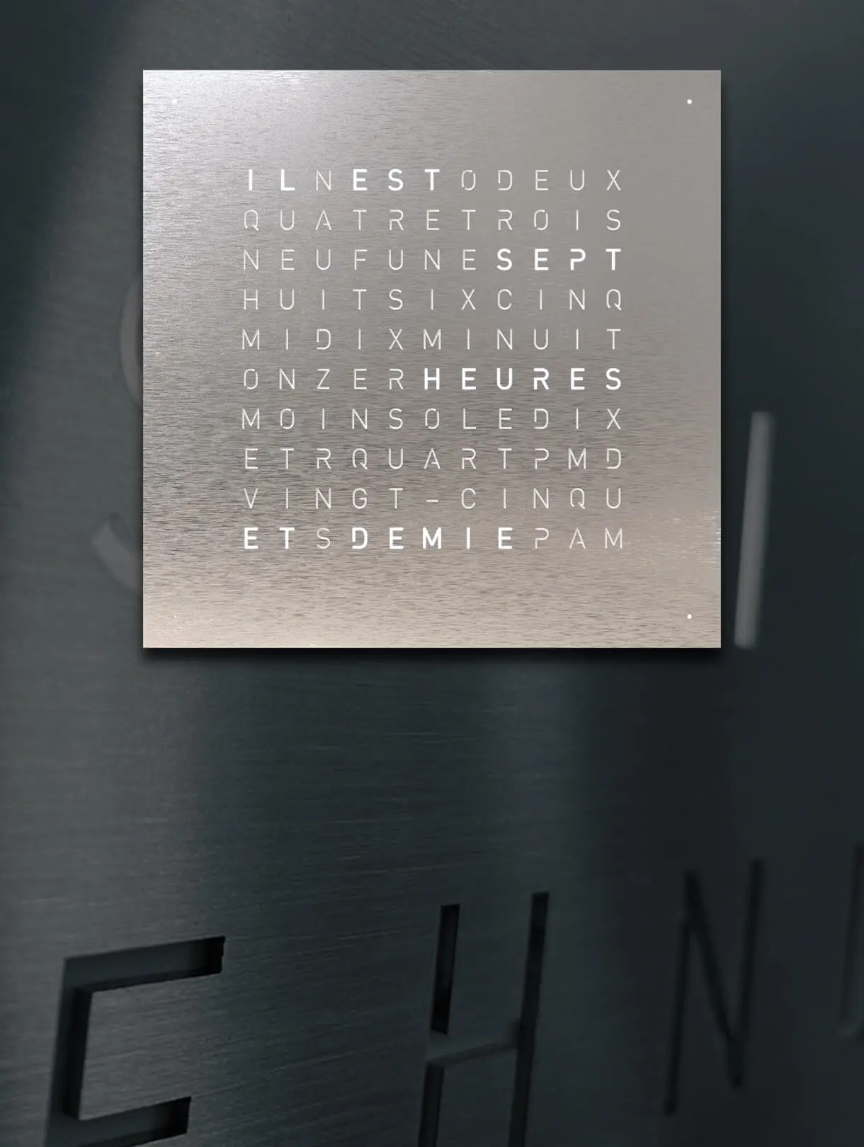 Front view of QLOCKTWO EARTH 45 Stainless Steel wall clock with typographic time display