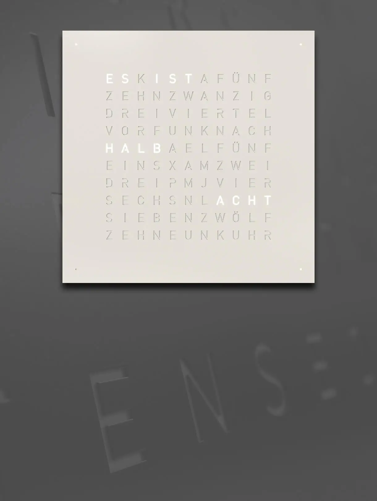 Front view of QLOCKTWO EARTH 45 White Pepper word clock with typographic time display