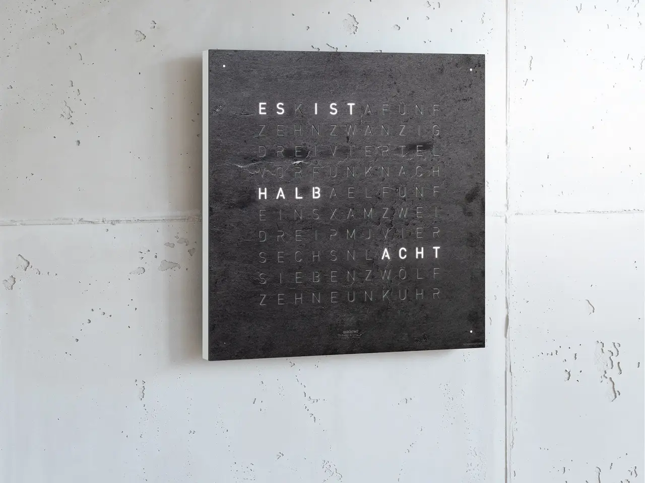 QLOCKTWO EARTH 45 Creator's Edition Metamorphite word clock with natural slate stone surface in an elegant interior
