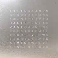 Front view of QLOCKTWO EARTH 45 Stainless Steel wall clock with typographic time display