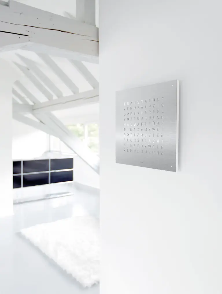 QLOCKTWO EARTH 45 Stainless Steel word clock with brushed metal surface in a modern interior