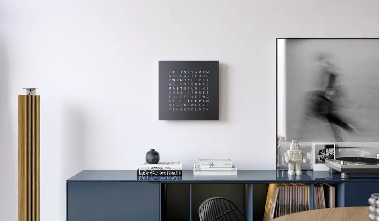 QLOCKTWO EARTH 45 Black Pepper word clock with black finish displayed in a modern living room
