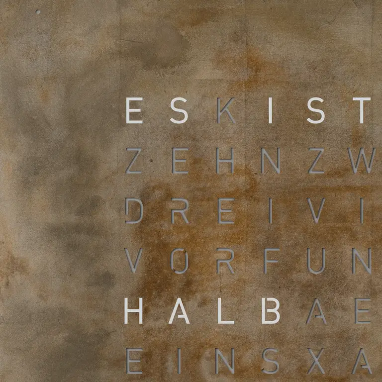 Close-up of QLOCKTWO EARTH 45 Creator's Edition Silver & Gold metal surface crafted with silver and gold leaf